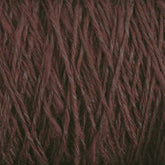 Close-up of a ball of yarn spun and dyed in Maine. The Halcyon Yarn Block Island Blend | Large Cone is dark maroon with a rich, textured appearance, showing the strands twisted together. The fibers look soft and slightly fuzzy, indicating a cozy material suitable for knitting or crocheting.