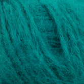 Close-up of a skein of Plymouth Baby Alpaca Brush yarn by Plymouth Yarn Co. The teal-colored fibers appear soft and fuzzy, suggesting a fluffy texture reminiscent of alpaca sweaters. The intertwined strands create a pattern of wavy lines.