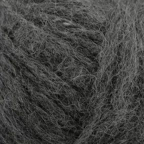 Close-up image of a ball of Plymouth Baby Alpaca Brush from Plymouth Yarn Co. in dark gray with a soft texture. The fibers are slightly loose, giving it a plush appearance, perfect for crafting alpaca accessories.