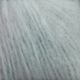 Close-up image of Plymouth Baby Alpaca Brush yarn by Plymouth Yarn Co. The light blue fibers are soft with a slightly fuzzy texture, creating a cloud-like appearance. Perfect for crafting cozy blankets or luxurious alpaca sweaters, the yarn is arranged in parallel strands, highlighting its thickness and smoothness.