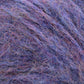 Close-up image of Plymouth Baby Alpaca Brush yarn by Plymouth Yarn Co. The multicolored yarn features a blend of blue, purple, and pink hues intertwined, creating a soft and textured appearance reminiscent of alpaca sweaters. The fibers are wispy and intricately interwoven.