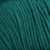 Close-up image of tightly wound, teal-colored Brown Sheep Cotton Fleece yarn, showcasing its soft and textured strands. The fibers appear slightly raised, enhancing the yarn's thickness and tactile quality. The overall appearance suggests it's suitable for knitting or crocheting intricate patterns.