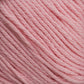 Close-up of Cotton Fleece by Brown Sheep, depicting the intricate texture of its soft and slightly twisted pink fibers. The uniform color throughout gives the yarn a smooth appearance, making it ideal for knitting patterns in soft pastels.