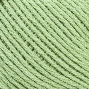 Close-up of a light green ball of Brown Sheep's Cotton Fleece yarn with tightly wound strands. The texture of the yarn is visible, showcasing the intertwined fibers, perfect for soft pastels in knitting patterns.