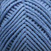 Close-up image of a skein of Brown Sheep's Cotton Fleece in blue, arranged in a neat, crisscross pattern. The texture and strands of the yarn are clearly visible, showing a rich, soft material perfect for knitting patterns.