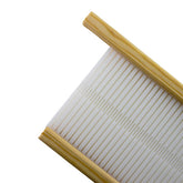 A Glimakra Siru Extra Rigid Heddle Reed from Glimakra, featuring an off-white, ribbed plastic mat set in a wooden frame. This component of a Rigid Heddle loom has evenly spaced parallel lines creating a textured surface and could potentially be repurposed as a sushi rolling mat or pasta drying rack. The photo captures the reed from an angled, close-up perspective.