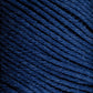 Close-up of Brown Sheep Cotton Fine, dark blue cotton yarn tightly wound into a ball. The texture of the yarn fibers is visible, showcasing a soft, slightly fuzzy surface perfect for machine knitters. The strands are neatly organized and evenly spaced.