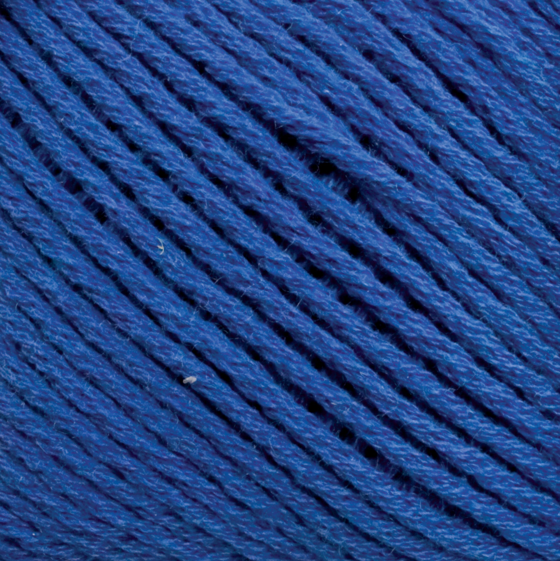 Close-up view of Brown Sheep's Cotton Fine blue cotton yarn strands tightly wound together. The texture and individual fibers of the yarn are clearly visible, showcasing the vibrant blue color and slightly varied hues within the strands—a perfect choice for machine knitters.