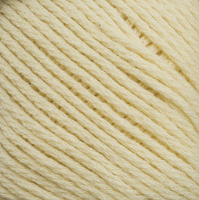 Close-up of a ball of Brown Sheep's Cotton Fine pale yellow yarn, showcasing its soft, fibrous texture and neatly wound strands. The yarn appears thick and cozy, suitable for knitting, crocheting, or even weaving projects.