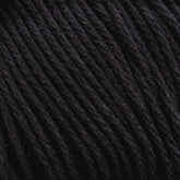 Close-up of Cotton Fine yarn by Brown Sheep. The image reveals tightly twisted black strands with a slightly glossy finish, suggesting it could be synthetic or a blend with natural fibers. The smooth texture makes it ideal for knitting, crocheting, or weaving projects for machine knitters.