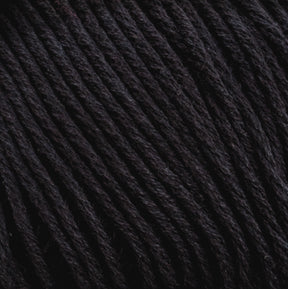 Close-up of Cotton Fine yarn by Brown Sheep. The image reveals tightly twisted black strands with a slightly glossy finish, suggesting it could be synthetic or a blend with natural fibers. The smooth texture makes it ideal for knitting, crocheting, or weaving projects for machine knitters.