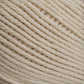 Close-up image of a ball of Cotton Fine yarn by Brown Sheep, showcasing the texture and tight weaving of the fibers. The yarn appears soft, with neatly arranged strands creating a diagonal pattern across the frame—a perfect choice for machine knitters.