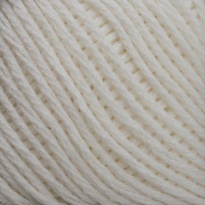 Close-up of a ball of Brown Sheep's Cotton Fine yarn in cream, highlighting its texture and tightly wound individual strands, ideal for weaving or machine knitting.