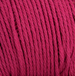 A close-up view of tightly wound, thick strands of Brown Sheep's Cotton Fine yarn in red. The texture and fiber details are visible, showcasing the intricacies of the plied threads, making it perfect for machine knitters.