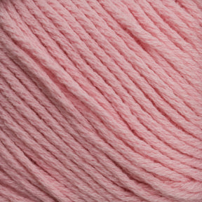 Close-up of Brown Sheep's Cotton Fine, featuring soft pastel pink cotton yarn with tightly woven strands that are neatly arranged to showcase its texture and color detail. The smooth and even fibers make it perfect for crafting crochet, knitting, or other textile projects, suitable for both hand crafters and machine knitters.