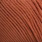 Close-up image of Brown Sheep's Cotton Fine yarn in orange, showcasing its tightly wound fibers. The texture is soft and the color is consistent throughout the strands, making it ideal for knitting, crocheting, or machine knitting.