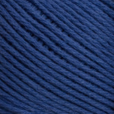 Close-up image of Brown Sheep's Cotton Fine yarn in dark blue. The yarn is neatly wound in a ball, with the individual strands tightly packed and running parallel to each other, showcasing its texture and thickness perfect for weaving or machine knitting.