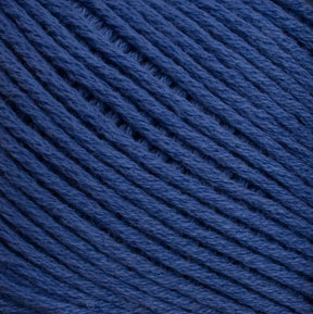 Close-up image of Brown Sheep's Cotton Fine yarn in dark blue. The yarn is neatly wound in a ball, with the individual strands tightly packed and running parallel to each other, showcasing its texture and thickness perfect for weaving or machine knitting.