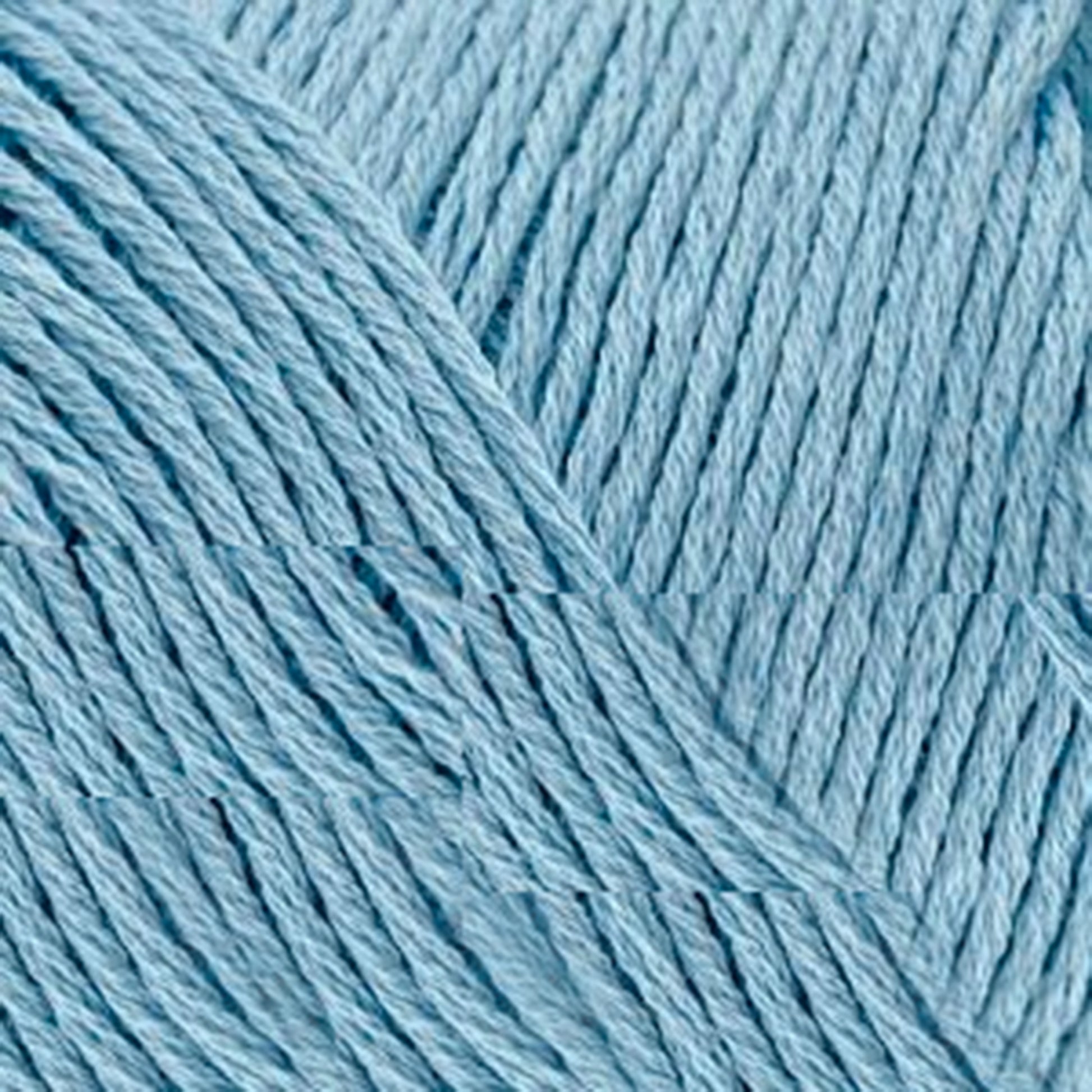 Close-up image of Brown Sheep Cotton Fine baby blue yarn, highlighting its finely woven texture and multiple strands twisted together. The yarn appears soft and smooth, making it ideal for knitting or crochet projects. Perfect for weaving yarn enthusiasts and machine knitters alike.