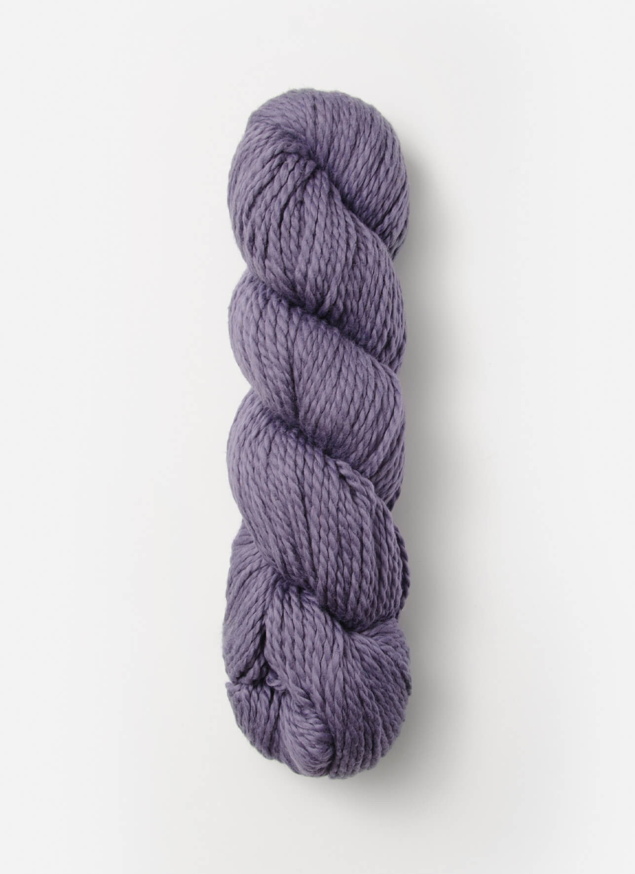 A tightly wound skein of Blue Sky Fibers Organic Cotton Worsted lies against a plain white background. The worsted weight yarn is thick and soft, with a subtle sheen, showcasing a consistent texture and twist—ideal for cozy baby knits.