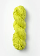 A twisted skein of Blue Sky Fibers Organic Cotton Worsted in a vibrant yellow-green hue, showcased against a plain white background. The yarn is thick, smooth, and appears soft, ideal for baby knits or other knitting or crocheting projects.