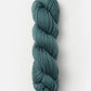 The Blue Sky Fibers Organic Cotton Worsted yarn in a beautiful teal color is neatly twisted into a loop. The fibers appear soft and slightly thick, making it ideal for knitting or crocheting cozy baby knits. The skein is set against a plain, light background with no additional objects in view.