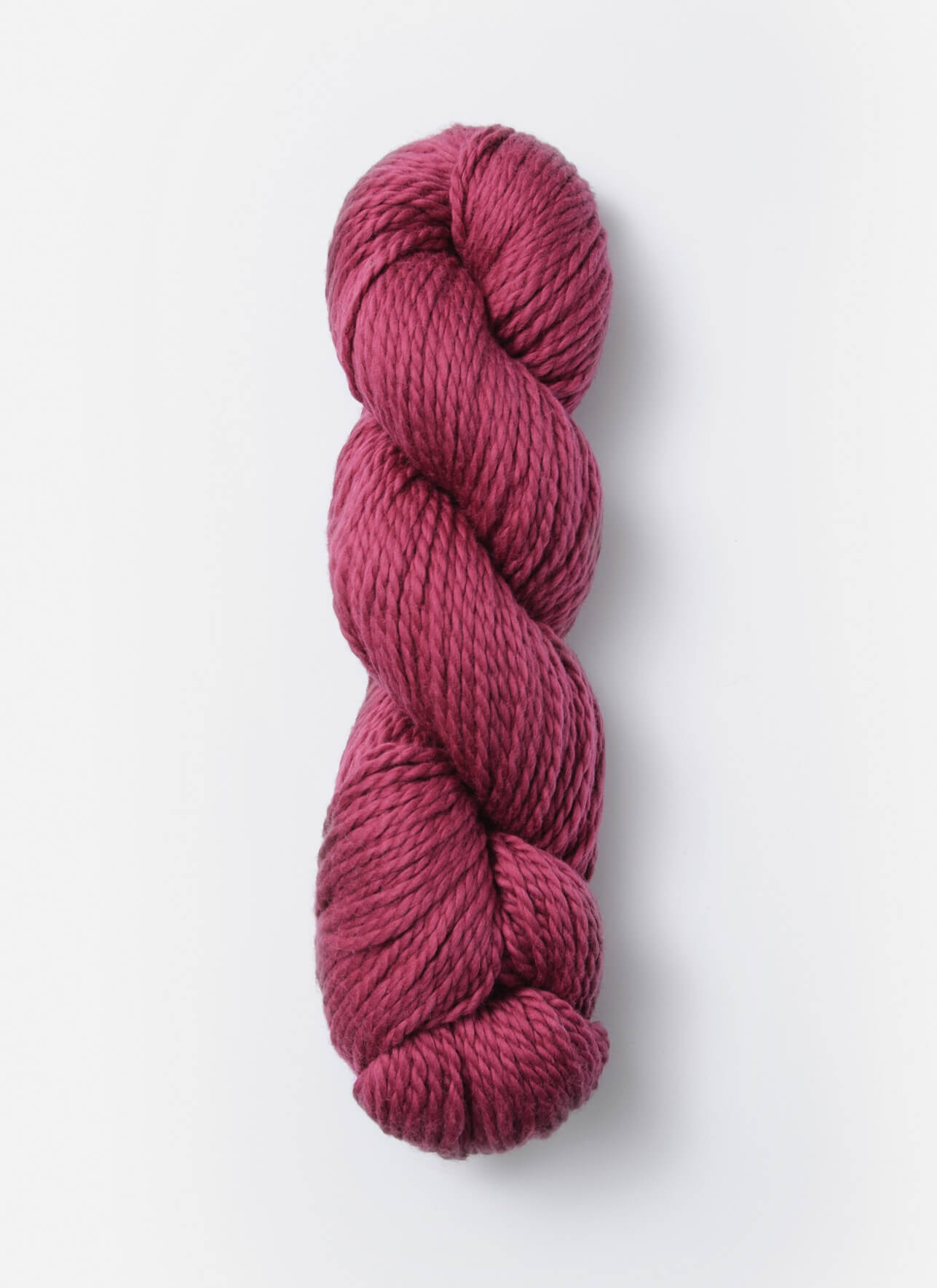 A skein of Blue Sky Fibers Organic Cotton Worsted yarn in a rich, burgundy color is displayed against a plain white background. The yarn appears soft and plush, making it perfect for baby knits or other cozy projects.