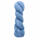 A twisted skein of Blue Sky Fibers Organic Cotton Worsted in a light blue hue set against a white background.