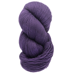 A skein of Cascade Eco and Cascade Eco Plus Wool Yarn from Cascade Yarns, featuring a neat coil of deep purple Peruvian Highland wool. Its soft and thick texture makes it ideal for knitting or crocheting projects, appealing to those in search of eco-friendly yarn options.