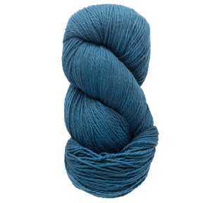 A skein of Cascade Eco and Cascade Eco Plus Wool Yarn by Cascade Yarns, made from eco-friendly Peruvian Highland wool, twists into a neat coil with its thick, teal hue. The yarn's soft and plush texture is ideal for felted knitting or crocheting projects.