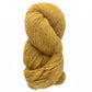 A skein of Cascade Eco and Cascade Eco Plus Wool Yarn in a rich golden yellow hue from Cascade Yarns is twisted into a coil against a white background. The texture has a slightly coarse quality, with subtle shade variations, indicating an eco-friendly yarn blend.