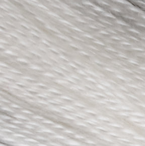 Close-up image of Henry's Attic 2/30 Natural Silk Yarn | Mini-Cone, showcasing its luxurious white fibers with a soft, wavy texture reminiscent of finely woven silk. The yarn appears dense and finely layered, creating a uniform pattern. The lighting highlights the subtle variations in the yarn's thickness and direction.