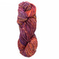 A skein of Malabrigo Mecha by Malabrigo Yarn, featuring vibrant shades of orange, purple, pink, and yellow twisted into a spiral. The kettle-dyed texture appears soft and chunky, making it ideal for knitting or crocheting cozy garments.