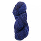 A skein of Malabrigo Mecha by Malabrigo Yarn, featuring thick, dark blue fibers twisted into a spiral, showcases varying shades of kettle-dyed blue for a textured appearance against a white background.