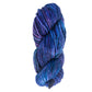 A skein of Malabrigo Yarn's Malabrigo Rasta, crafted from thick, soft merino wool in shades of blue and purple, offers a plush texture with a slightly twisted appearance.