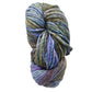 A skein of Malabrigo Rasta from Malabrigo Yarn, this super bulky yarn is a luxurious twist of thick, multicolored merino wool showcasing rich shades of green, blue, purple, and brown.