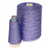 Two spools of Astra Glow Metallic thread from Huntingdon Yarn Mill, Inc. are positioned side by side against a white background. The larger spool, named "Astra Glow Metallic | Large Cone," is on the right, and the smaller one on the left. Both spools, made from metallic yarn, have a shiny texture that reflects light and showcases their vibrant purple color.