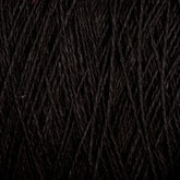 Close-up image of a bundle of dark black threads or yarn strands, tightly wound together with visible texture and slight variations in the direction of the fibers. The dense and soft Homestead 8/2 Cotton Yarn from Supreme Corp appears suitable for knitting, crocheting, or weaving projects, and is conveniently machine-washable. This large cone ensures you have ample material for your crafting needs.