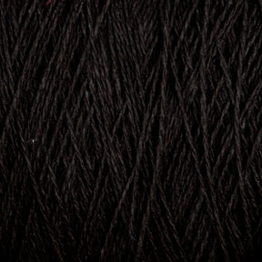 Close-up of Homestead 8/2 Cotton Yarn | Mini-cone by Supreme Corp. The tightly wound fibers create a dense, textured appearance with intertwining strands, highlighting the quality of this versatile black yarn.