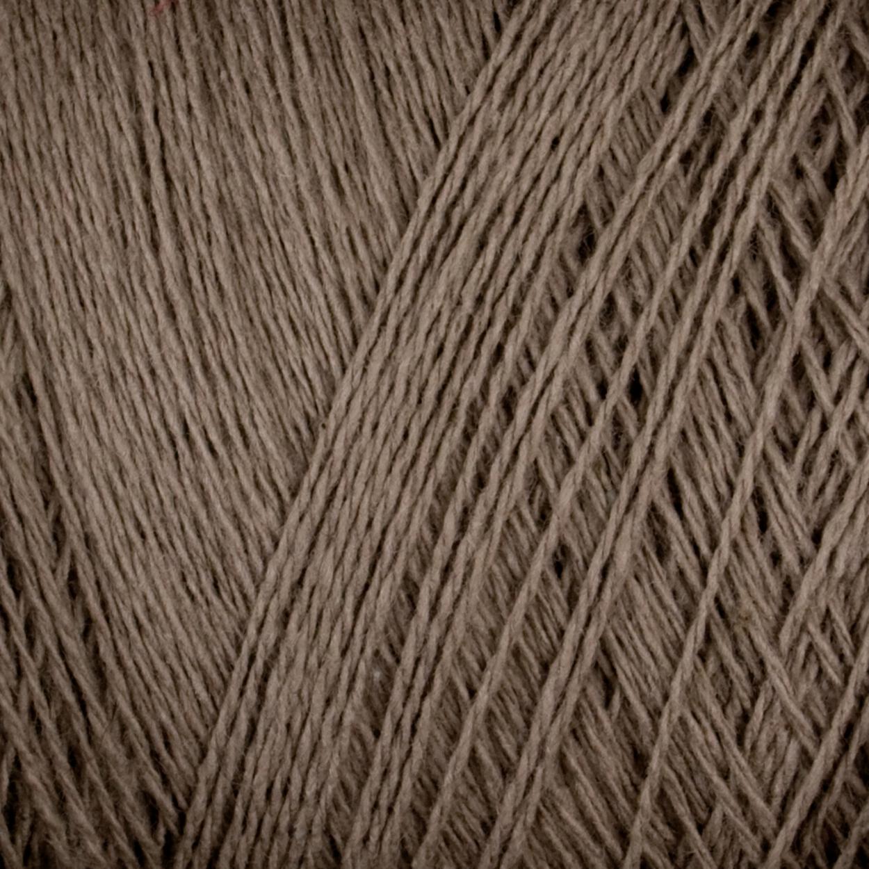 Close-up image of Supreme Corp's Homestead 8/2 Cotton Yarn on a large cone, showcasing the fine, tightly interwoven fibers. The texture appears soft and slightly fuzzy, indicative of natural fiber. The yarn strands are uniformly twisted, creating a consistent pattern across the image.