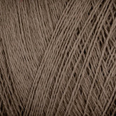 Close-up image of multiple strands of Homestead 8/2 Cotton Yarn from Supreme Corp in natural colors, tightly wound together to form a mini-cone. The texture is coarse and fibrous, showcasing the intricate details of the yarn fibers. The color is a neutral beige or light brown shade, perfect for weaving projects.