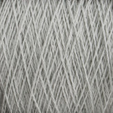 Close-up view of Supreme Corp's Homestead 8/2 Cotton Yarn | Large Cone in pale gray, wound neatly into a skein. The individual strands of this weaving yarn are tightly interwoven, creating a textured pattern. The image focuses on the details of the fibers and the uniformity of the winding.