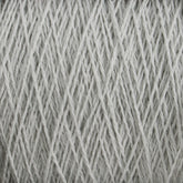 Close-up of a ball of light gray, machine-washable Homestead 8/2 Cotton Yarn | Mini-cone by Supreme Corp, showing tightly wound strands in a textured pattern. The yarn has a soft, slightly fuzzy appearance, and the crisscrossing fibers create a detailed, intricate visual.