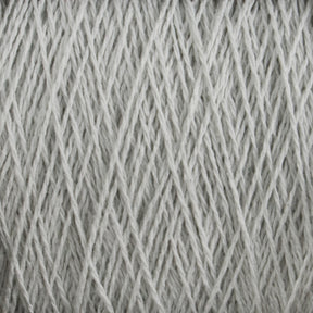 Close-up of a ball of light gray, machine-washable Homestead 8/2 Cotton Yarn | Mini-cone by Supreme Corp, showing tightly wound strands in a textured pattern. The yarn has a soft, slightly fuzzy appearance, and the crisscrossing fibers create a detailed, intricate visual.