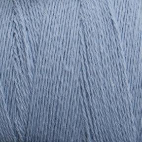 A close-up image of Homestead 8/2 Cotton Yarn from Supreme Corp in light blue, showcasing the intricate texture of the fibers. The yarn appears soft and slightly fuzzy, giving it a cozy, delicate look perfect for knitting or crocheting projects. Additionally, its machine-washable feature adds convenience to its charm.