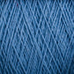 Close-up image of a spool of Supreme Corp's Homestead 8/2 Cotton Yarn in blue, showing its detailed woven fibers and texture. This machine-washable yarn appears tightly wound with a consistent thickness, making it ideal for all your weaving projects.