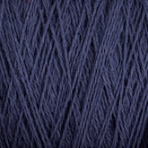 Close-up image of a Homestead 8/2 Cotton Yarn | Mini-cone from Supreme Corp in dark blue. The machine-washable strands are neatly intertwined, showcasing the texture and detail of the fibers. The color is consistent throughout, giving a rich, deep blue appearance perfect for various versatile projects.