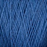 Close-up image of Supreme Corp's Homestead 8/2 Cotton Yarn in blue fibers arranged in an intricate, interwoven pattern. The texture is detailed, highlighting the strands and their varying thicknesses, creating a rich and tactile visual. This machine-washable weaving yarn offers both beauty and practicality.