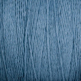 A close-up image of Supreme Corp's Homestead 8/2 Cotton Yarn in medium blue. The interwoven yarn strands create a textured pattern, showcasing the smooth and slightly fuzzy texture. This fine and high-quality fiber is machine-washable, ideal for various textile projects.