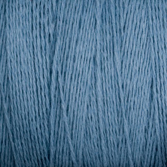 A close-up image of Supreme Corp's Homestead 8/2 Cotton Yarn in medium blue. The interwoven yarn strands create a textured pattern, showcasing the smooth and slightly fuzzy texture. This fine and high-quality fiber is machine-washable, ideal for various textile projects.